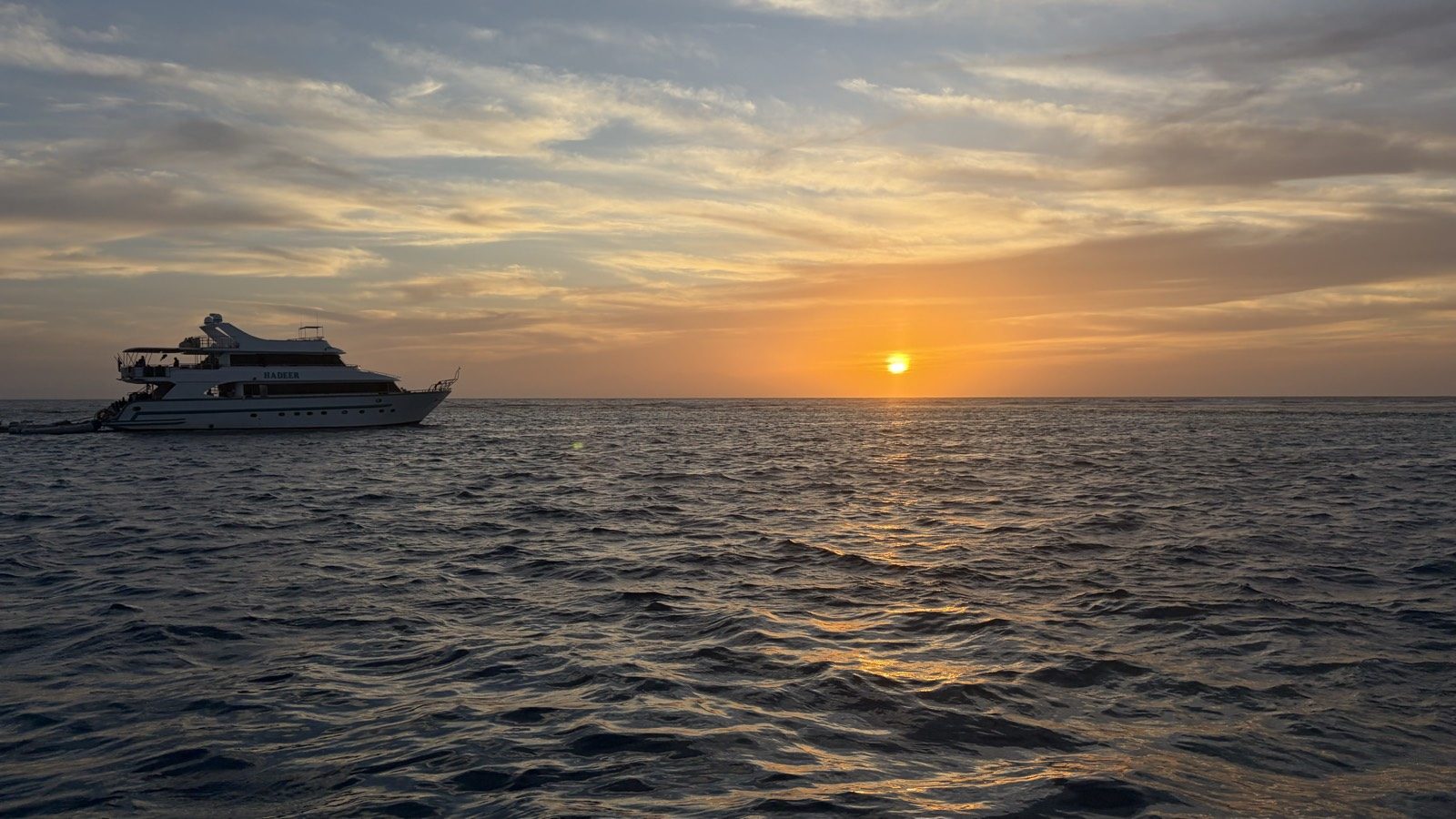 A yacht anchored on the Red Sea at golden sunset
